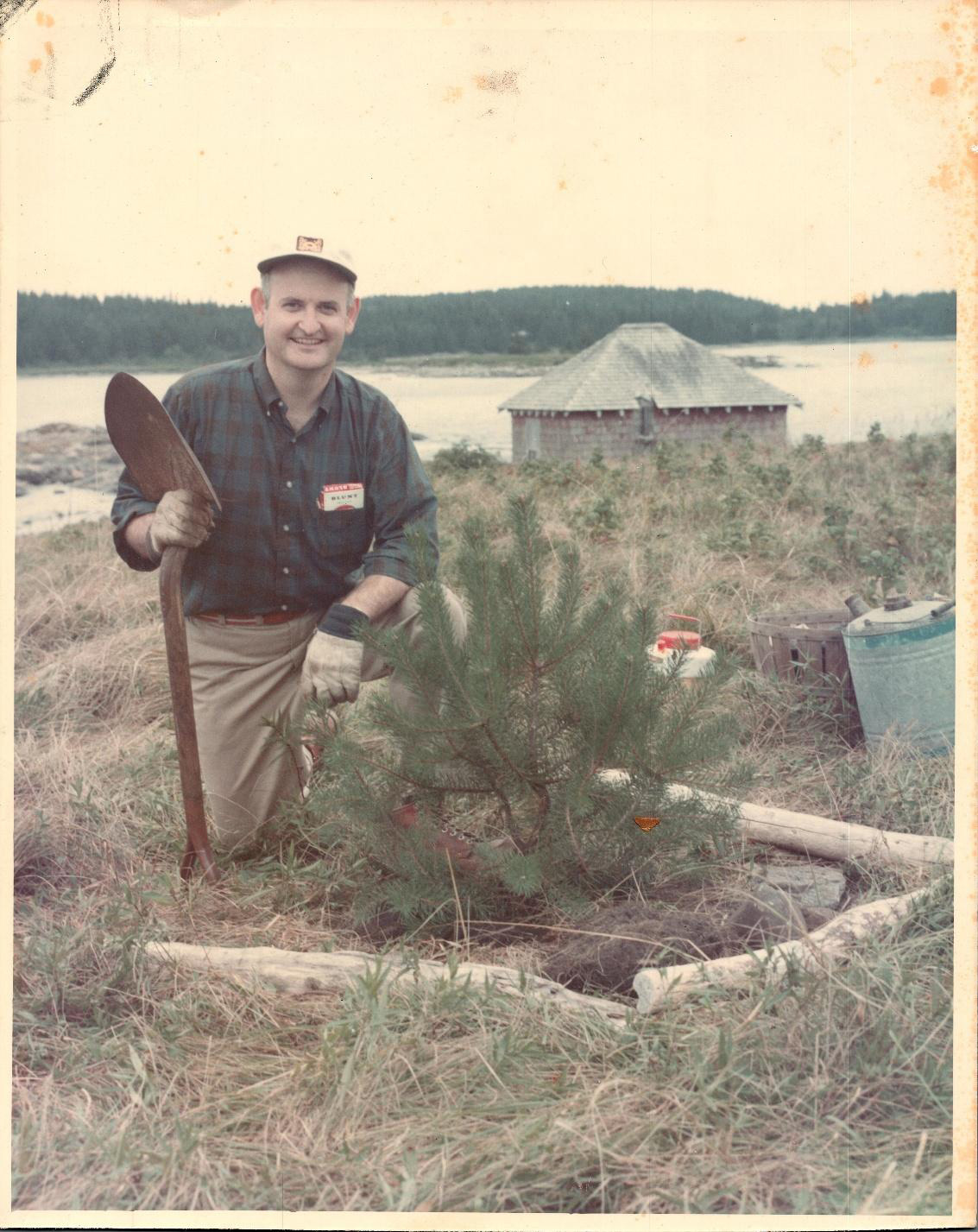 James Arey planting trees to reclaim de-forested land in 1970's.